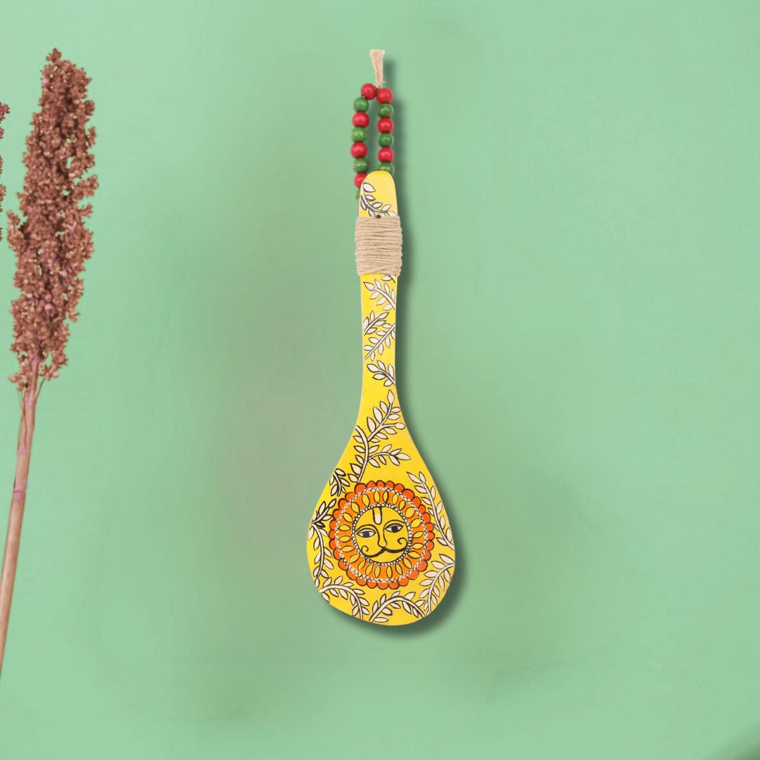 Click to see full view    Indha Hand-Painted Wooden Spoon Décor – Madhubani Sun Art | Yellow Wall Accent with Jute & Beads | Travel-Friendly Indian Souvenir | Handmade Gift