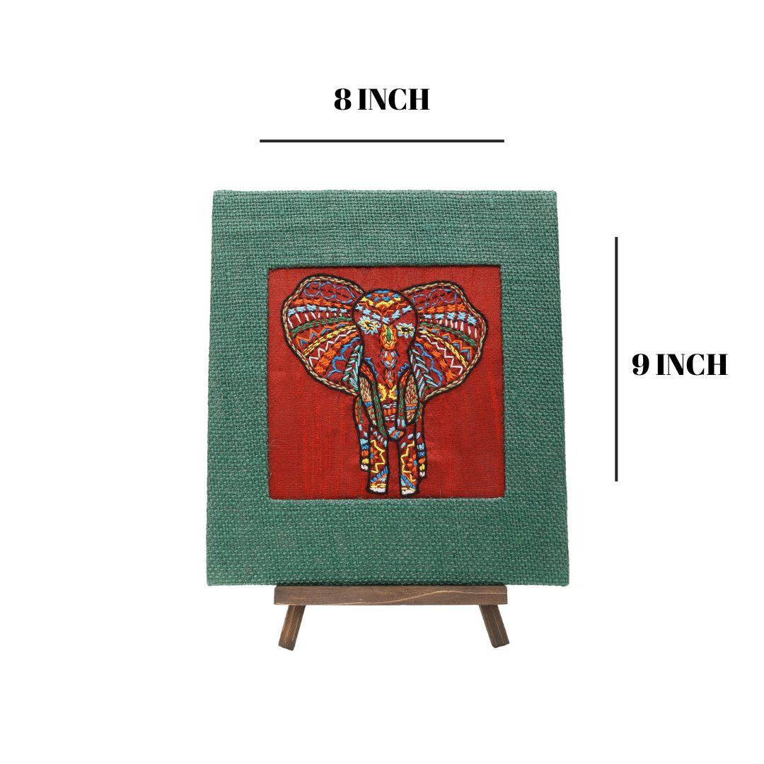Indha Hand-Embroidered African Elephant – Silk Textile Art with Mini Wooden Easel A vibrant elephant motif stitched on rich silk—tabletop ready, gift-ready