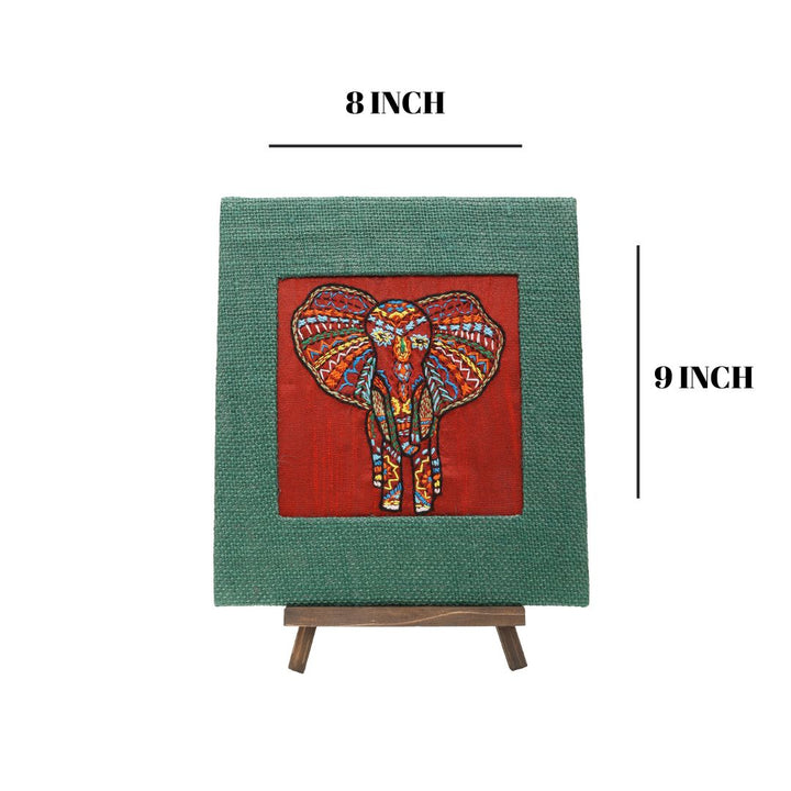 Indha Hand-Embroidered African Elephant – Silk Textile Art with Mini Wooden Easel A vibrant elephant motif stitched on rich silk—tabletop ready, gift-ready