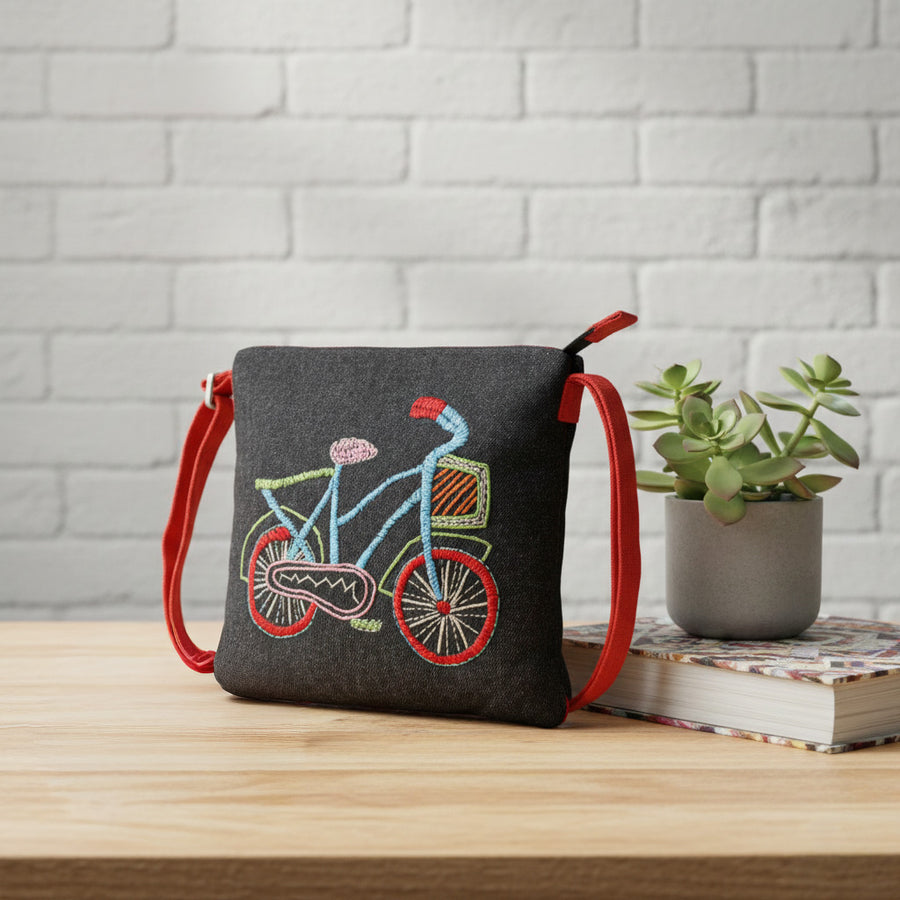 Handmade embroidered sling bag with bicycle motif