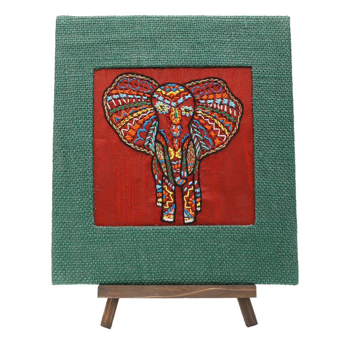 Indha Hand-Embroidered African Elephant – Silk Textile Art with Mini Wooden Easel A vibrant elephant motif stitched on rich silk—tabletop ready, gift-ready