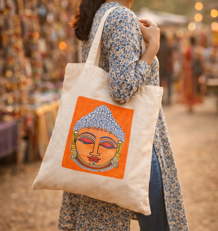 Indha Tote Bag with Lord Buddha Face Print |  Hand Block Printed Natural Cotton Shopping Bag | White and Orange Tote Bag | Eco-Friendly Handcrafted Tote | Single Compartment with Small Pocket | Button Closure | Vibrant and Spacious Bag |